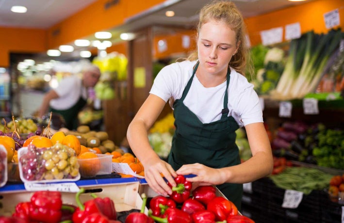 Teenager working in a grocery shop
