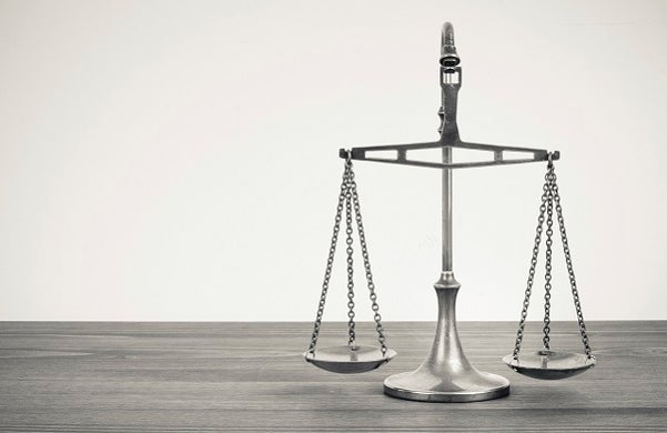 silver balancing scales on a desk
