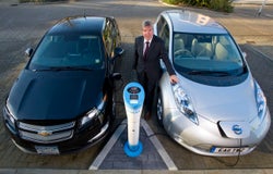 2 electric cars charging next to each otther