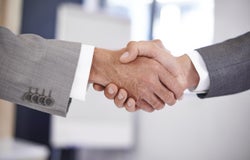 Close up of two hands shaking as if to seal a deal