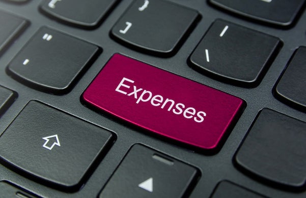 Close-up of a keyboard with an Expenses button in red.
