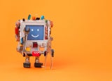 A smiling toy robot on orange background