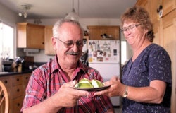 Elderly person giving food to another