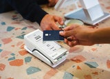 A person taps their payment card on a POS device