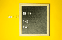 Black square board on a yellow background with the text 