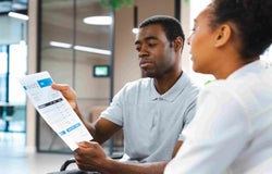 Two people discussing an invoice