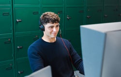 Man smiling while looking at a telephone system