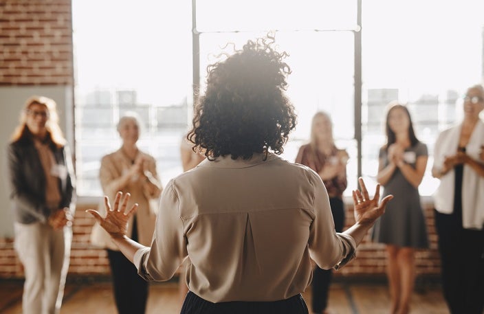 Back shot of a women addressing a group of other women