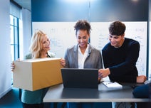 Women with packaging, talking to colleagues