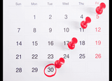 Dates marked on a calendar with pins