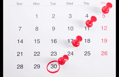 Dates marked on a calendar with pins