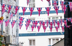 British Union Jack flag triangular hanging in preparation for a street party. Festive decorations of Union Jack bunting.