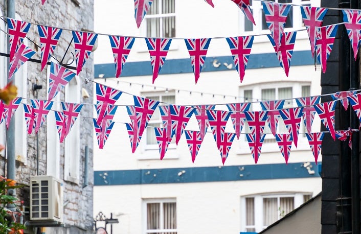 British Union Jack flag triangular hanging in preparation for a street party. Festive decorations of Union Jack bunting.
