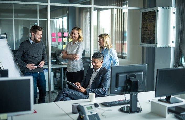 Happy team of coworkers working together in an office.