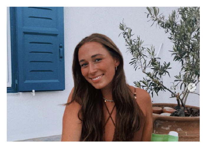 Image of a young woman smiling whilst on holiday, taken from Instagram