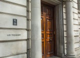 Image of the front door to the HM Treasury building on Horse Guard Road, Whitehall with the words 'HM Treasury' painted onto the wall.