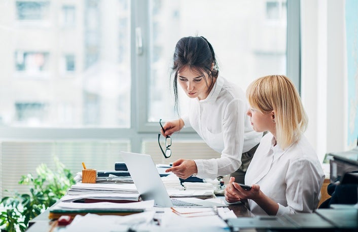 Colleagues working in office in front of computer