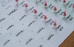 4 day work week printed calendar with pink pins on three days off in week weekend days four day working week concept. Modern approach doing business short workweek. Effectiveness of employees. Productivity and efficiency days off