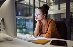 Burnout, report and compliance with a business woman working on a computer in her office late at night. Stress, frustrated and problem with an anxious female employee at work on a company deadline.