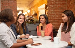 female employees in a meeting room having a work discussion
