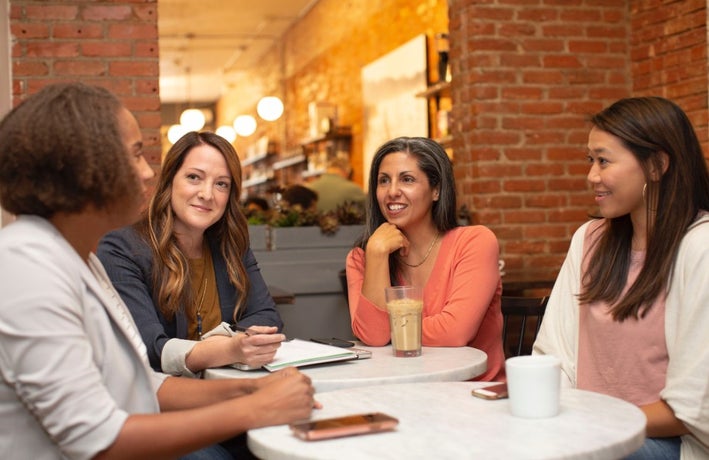 female employees in a meeting room having a work discussion