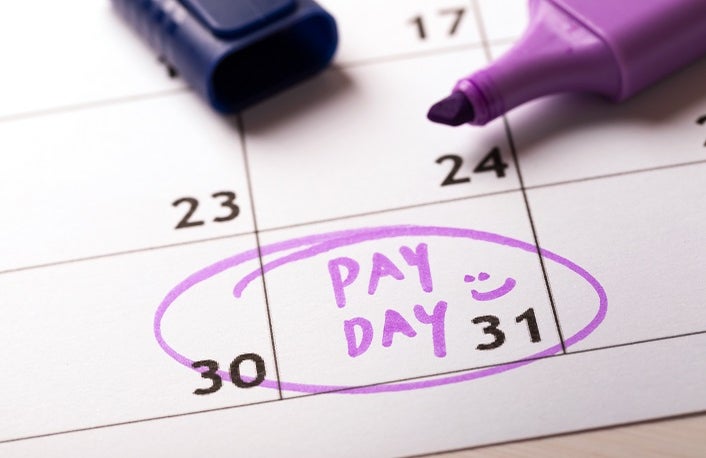 payday concept calendar with marker and circled day of salary