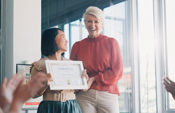 Applause, award and success with business woman in meeting for goal, thank you and winner. Celebration, praise and promotion with business people and certificate for support, achievement and branding.