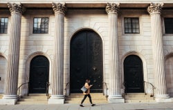 A woman walking past a bank