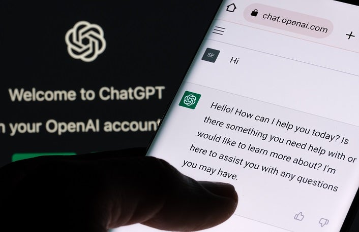 ChatGPT chat bot screen seen on smartphone and laptop display wi