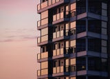 A close-up image of a block of flats at sunset