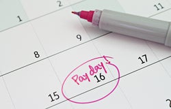 Close up of a calendar with pay day circled in pen.