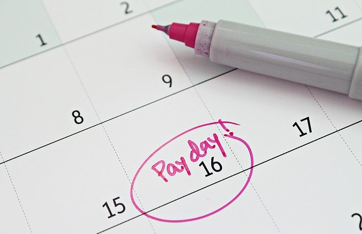 Close up of a calendar with pay day circled in pen.
