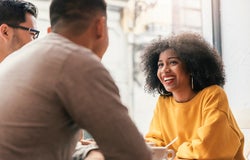 Group of happy friends chatting in the coffee shop.