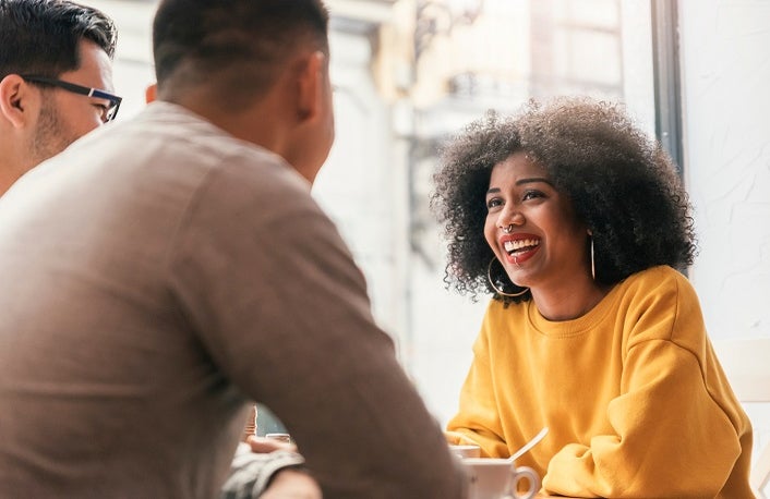 Group of happy friends chatting in the coffee shop.