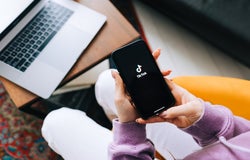 Woman holding iPhone with TikTok app logo on the screen. Rostov-