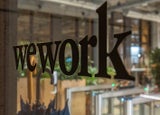 wework lettering on the glass door at night