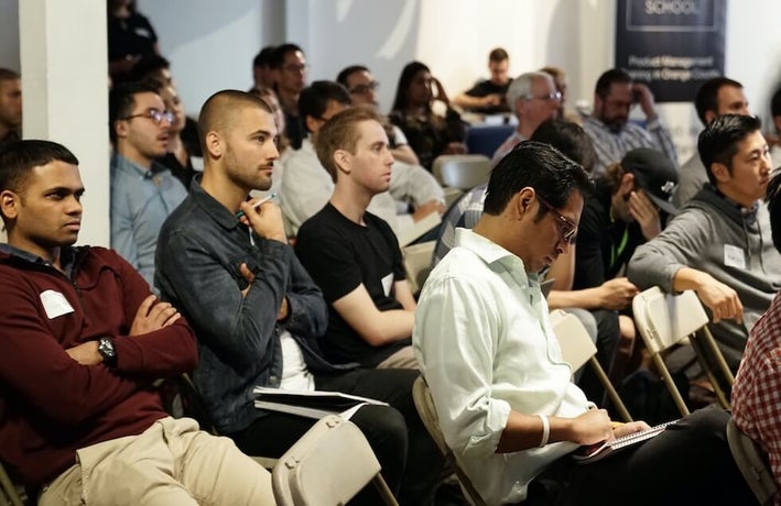 a group of disengaged employees sitting through a presentation