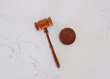 a top-down image of a gavel on a marble worktop