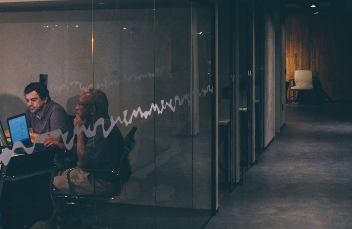 two men working in a dark office