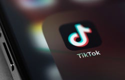 TikTok icon mobile app on screen smartphone iPhone closeup. TikTok is app to create and share videos