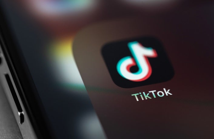 TikTok icon mobile app on screen smartphone iPhone closeup. TikTok is app to create and share videos