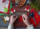 Making of handmade christmas toys from felt with your own hands. Children's DIY concept. Making xmas tree decoration or greeting card. Step 3. Decorate the toy.