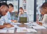 Business people, team and woman with headache in meeting at office, mistake and fail. Stress, group and person frustrated in problem, financial crisis or fear for challenge of tax debt in bankruptcy.