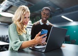 Group of people looking at a business phone
