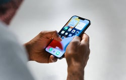 Image of an employee holding a Smartphone Texting & Calling