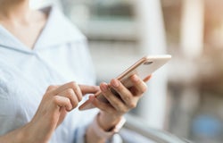 woman using smartphone on staircase in public areas, During leisure time. The concept of using the phone is essential in everyday life.