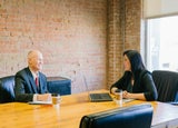 Two coworkers having a meeting in a meeting room