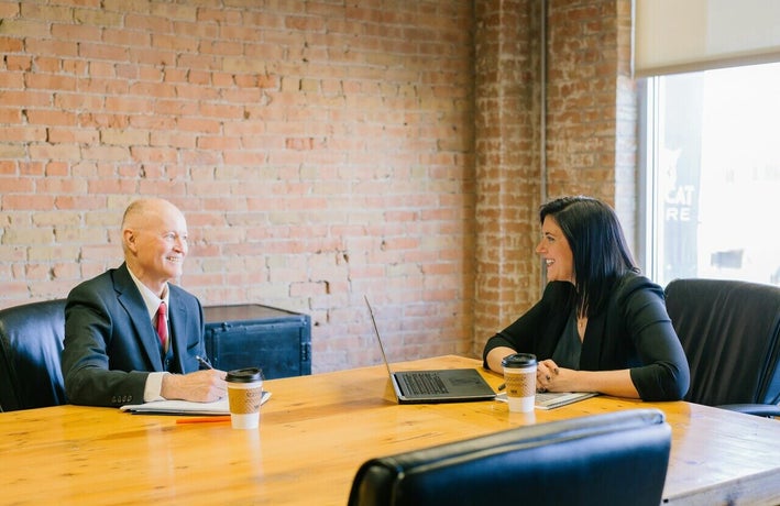 Two coworkers having a meeting in a meeting room