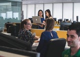 Employees chatting in a shared office space