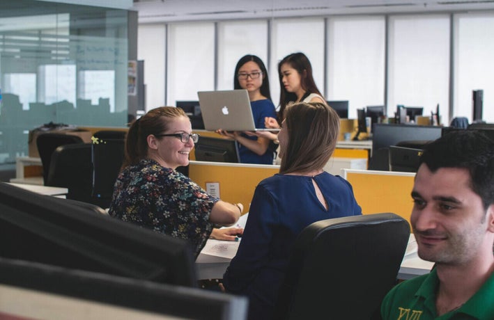Employees chatting in a shared office space